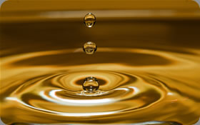 Water dripping into a pool of gold water